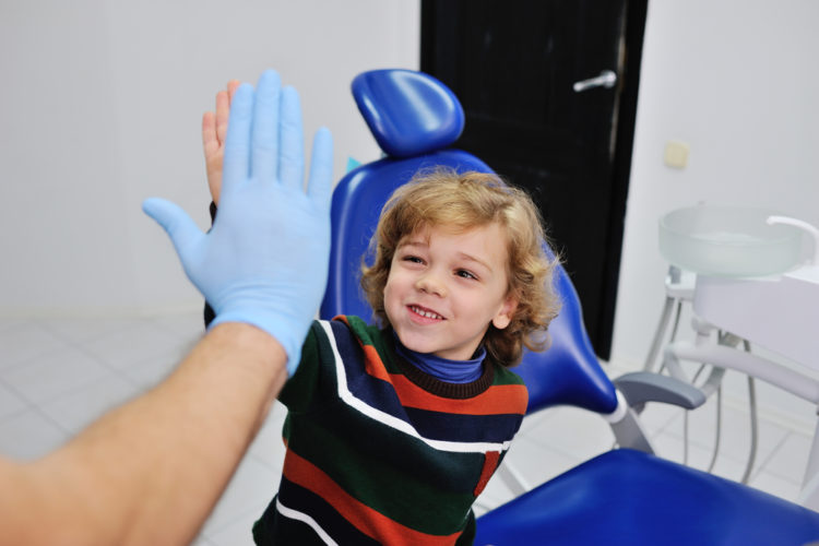 Child high-fiving dentist