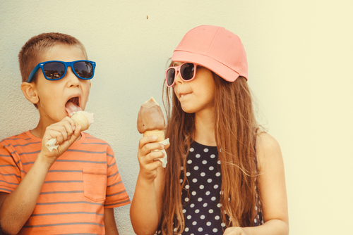 Two kids eating ice cream before their pediatric dentist visit.