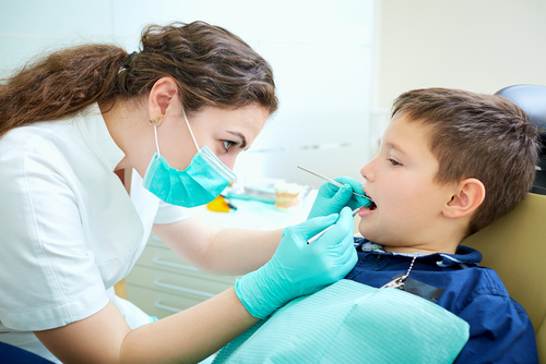Dentist cleaning teeth