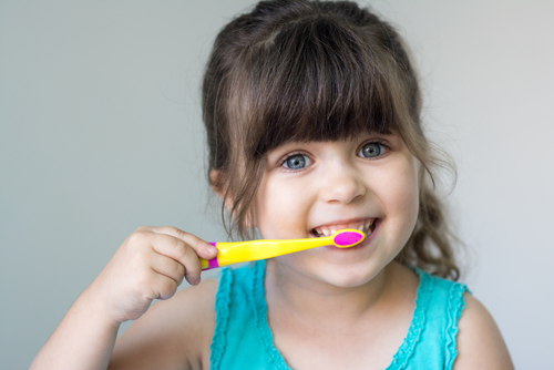 toddler brushing her teeth