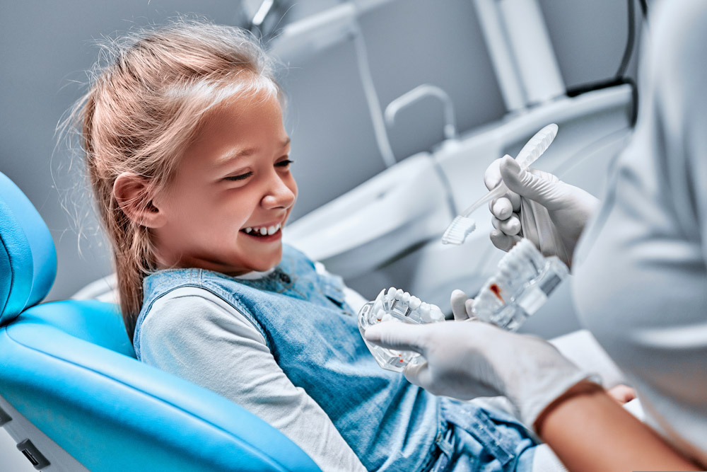 Young patient undergoing a cleaning at a pediatric dentist office