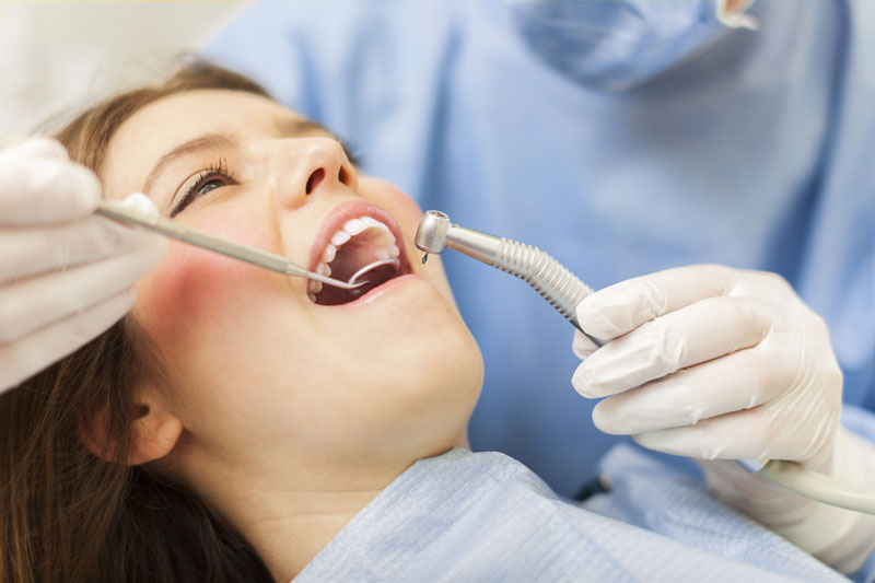 Woman having a cavity filled at the dentist